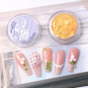 Close-up of lilac and orange pastel petal nail art sequins with floral nail design samples
