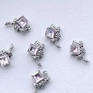 Pink crystal square nail decorations with detailed silver bow frame