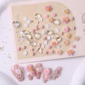 Pink and yellow rose nail embellishments with glittering crystals and pearls