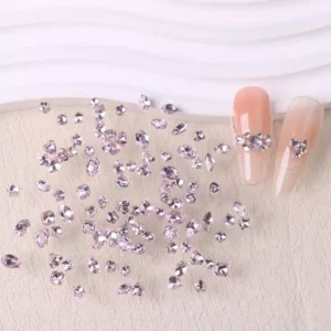 Pink nail crystals mix featuring oval and star rhinestones on light peach nails