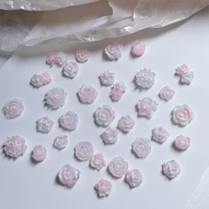 Light pink resin rose nail charms with layered petal design