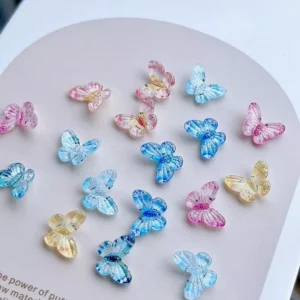 Close-up of colorful pastel fairy butterfly nail decorations