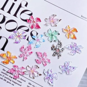 Mixed color 3D lily nail stickers in floral shapes on a paper surface