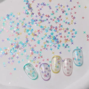 Multicolor iridescent star glitter scattered across a white background with sample nails