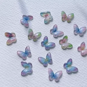 Light-catching butterfly nail charms with delicate rainbow striping on each wing