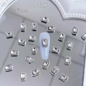 Rectangle-cut silver crystal nail charm with rhinestone trim on blue base