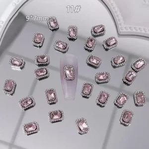 Rectangular emerald-cut pink crystal nail decoration with rhinestone trim
