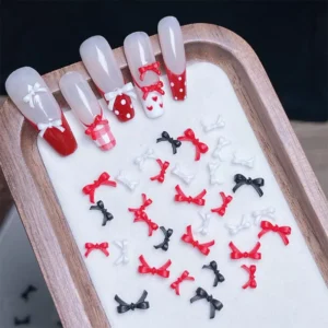 Red, black, and white 3D bow tie nail charms set with long nail display