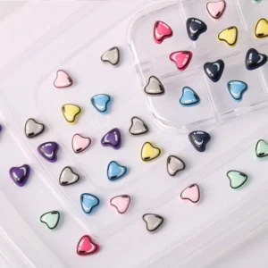 Heart shaped dopamine nail charms in various colors stored in a clear organizer