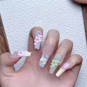 Long nails with 3D floral charms and pastel accents