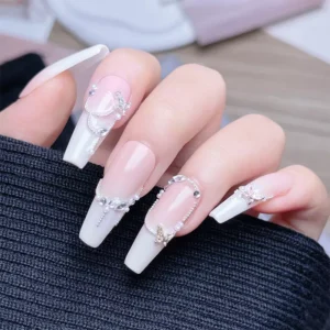 Long almond nails decorated with rhinestones and butterfly charms