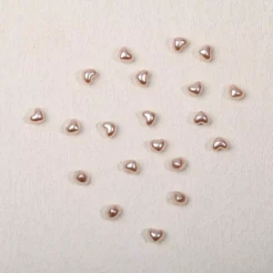 Close-up of pearl rose heart resin nail charms