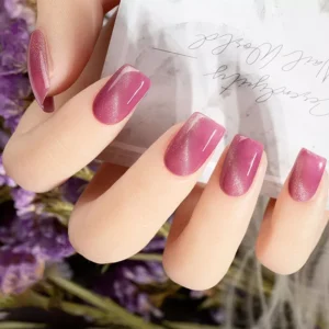 Iridescent mauve and rose magnetic nail polish worn on nails