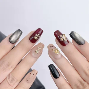 Full hand showing alloy floral nail charms in a complete nail design set