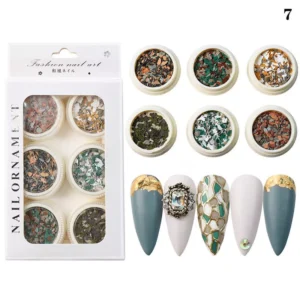 Forest-inspired crushed stone flakes in dark greens and rust tones with elegant matte nails