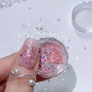 Pale pink dried flower nail art glitter in pot and on finger