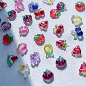Glossy resin fruit nail charms in high-saturation light