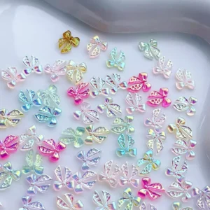 Assorted shiny resin bow nail charms in various pastel hues