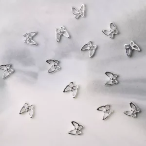 Silver butterfly nail charms with clean reflective finish