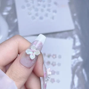 Single pastel ice flower nail charm applied over sheer pink design