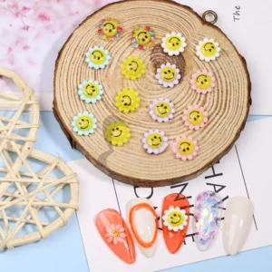 Assorted pastel smiley bloom charms arranged on wood tray with nail tips