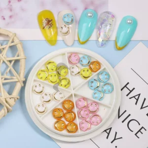 Close-up of pastel smiley flower nail charms with sample nail art on blue background