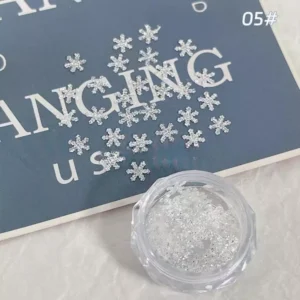 Glitter snowflake sequins for nails in clear pot with bright reflection