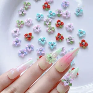 Assorted pastel 3D flower nail charms with rhinestone centers on display