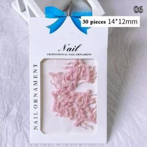 Soft pink bow ribbon nail charms in professional packaging with 30 pieces