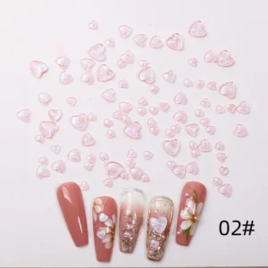 Pink iridescent heart nail charms with glossy pastel finish