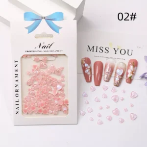 Pink heart nail charms in gift-ready packaging with floral nails