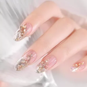 Galaxy Crystal Nail Glitter applied on nude acrylic nails for shimmering gradient effect