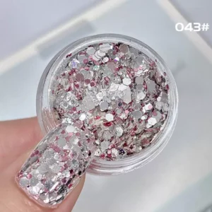 Close-up of silver and pink holographic nail glitter mix in hex shapes with high shine
