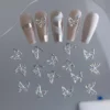 Sparkling butterfly nail charms displayed on nude nails