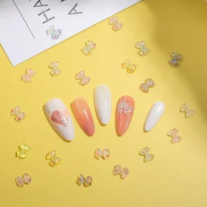 Iridescent crystal bow nail charms with AB shimmer effect