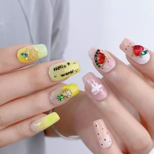 Summer-themed nail design with lemon and watermelon crystal charms