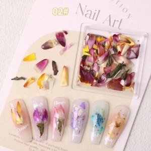 Mixed vibrant red, yellow, and pink flower petal nail decorations in a square container
