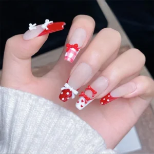 Complete red and white manicure with dotted and heart designs and bow ties