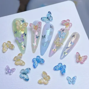 Iridescent butterfly nail charms displayed on nail tips