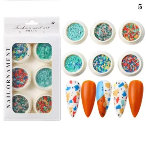 Crushed stone nail flakes in bright turquoise and coral tones with abstract nails