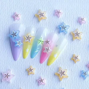 Assorted pastel 3D starfruit charms arranged on gradient nail tips