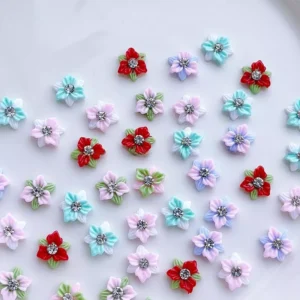 Mixed color five-petal nail flower charms with rhinestones and green accents