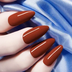 Chestnut brown gel nails on model hand with satin fabric background