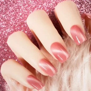 Pink cat eye magnetic polish applied on manicure nails