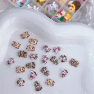 Soft pink and yellow nail art with Mikko charms and heart accents