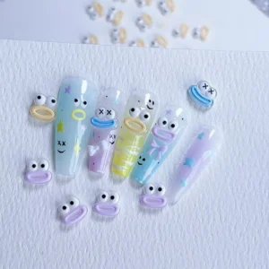 Mixed monster nail charms laid out with nail tip design samples