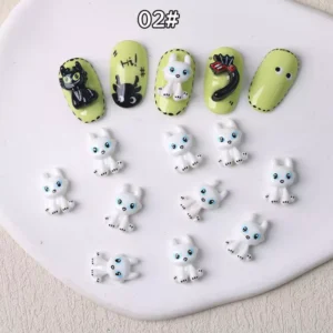 White cartoon kitten nail charms with blue eyes and soft finish