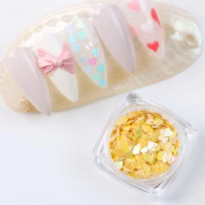 Yellow iridescent heart nail sequins with matching nail art on shell palette