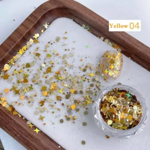 Yellow holographic nail glitter spilled from jar with gold stars and hearts