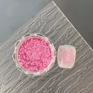 Heart-shaped glitter in pastel yellow tones for nail decoration.
